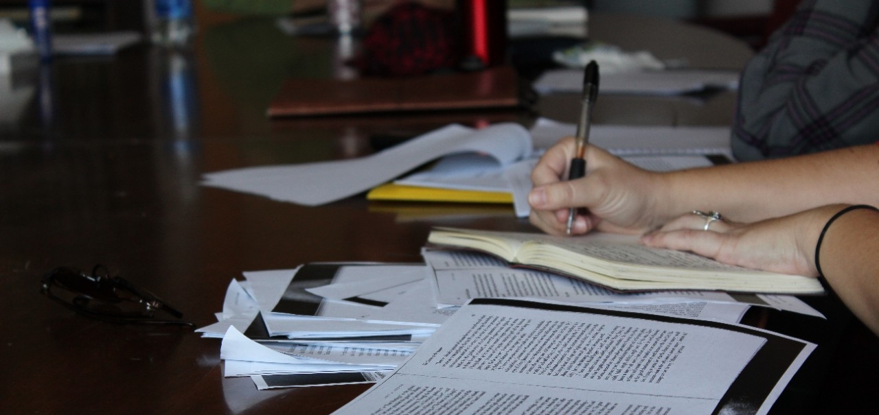 person taking notes at a table