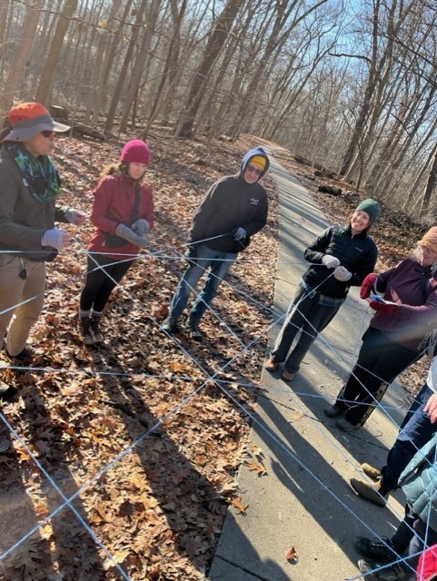 HIke + Write event picturing a group connected by string