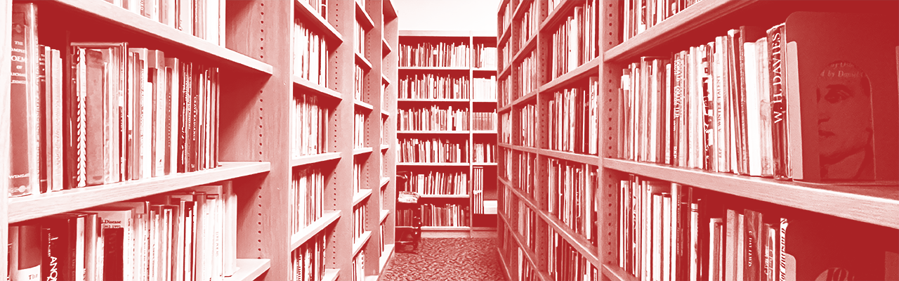 A view down an aisle of bookshelves full of books in the Elliston Stacks