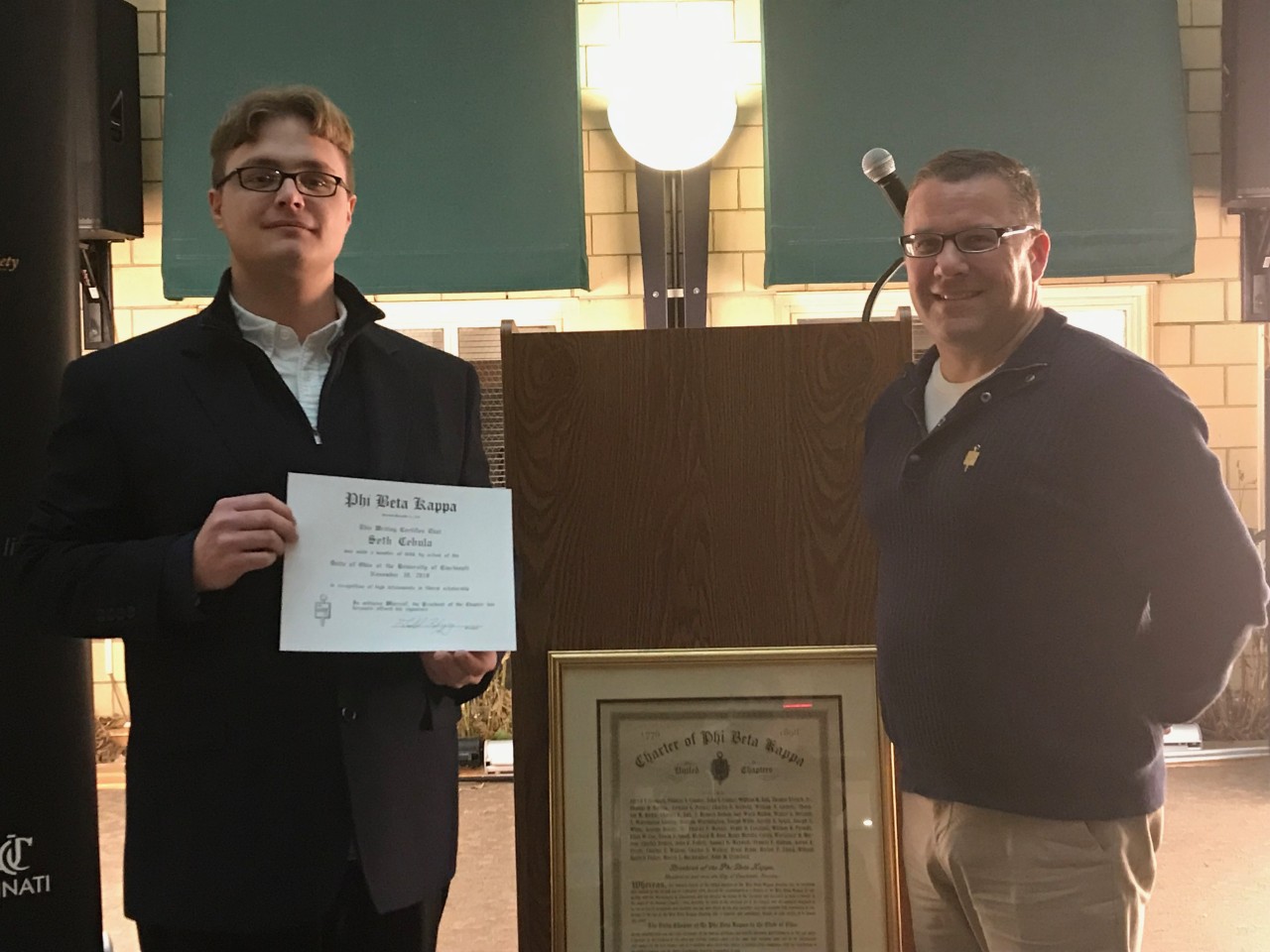 Seth Cebula receiving his Phi Beta Kappa certificate from Jeff Zalar