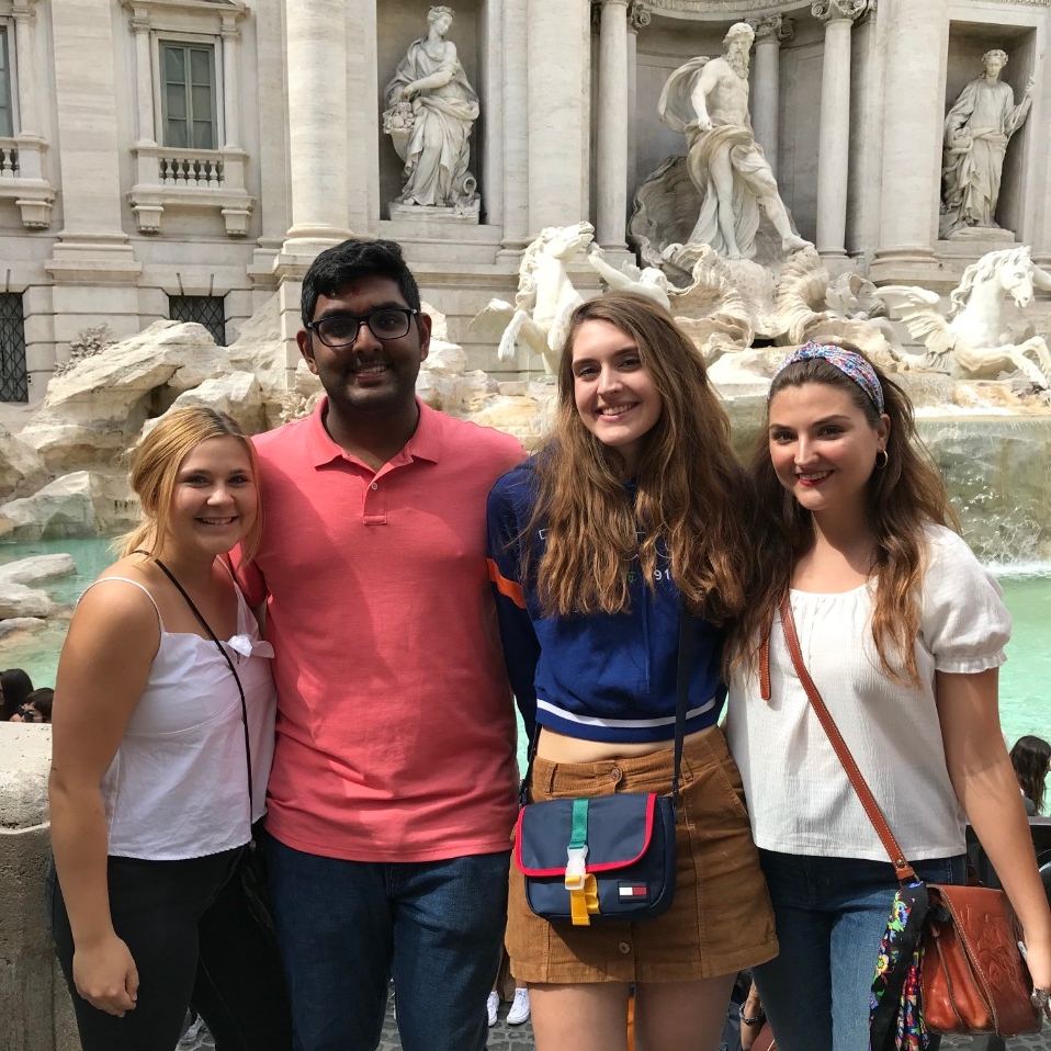 Four students pose in front of Fontana dei Quattro Fiumi a Piazza Navona.