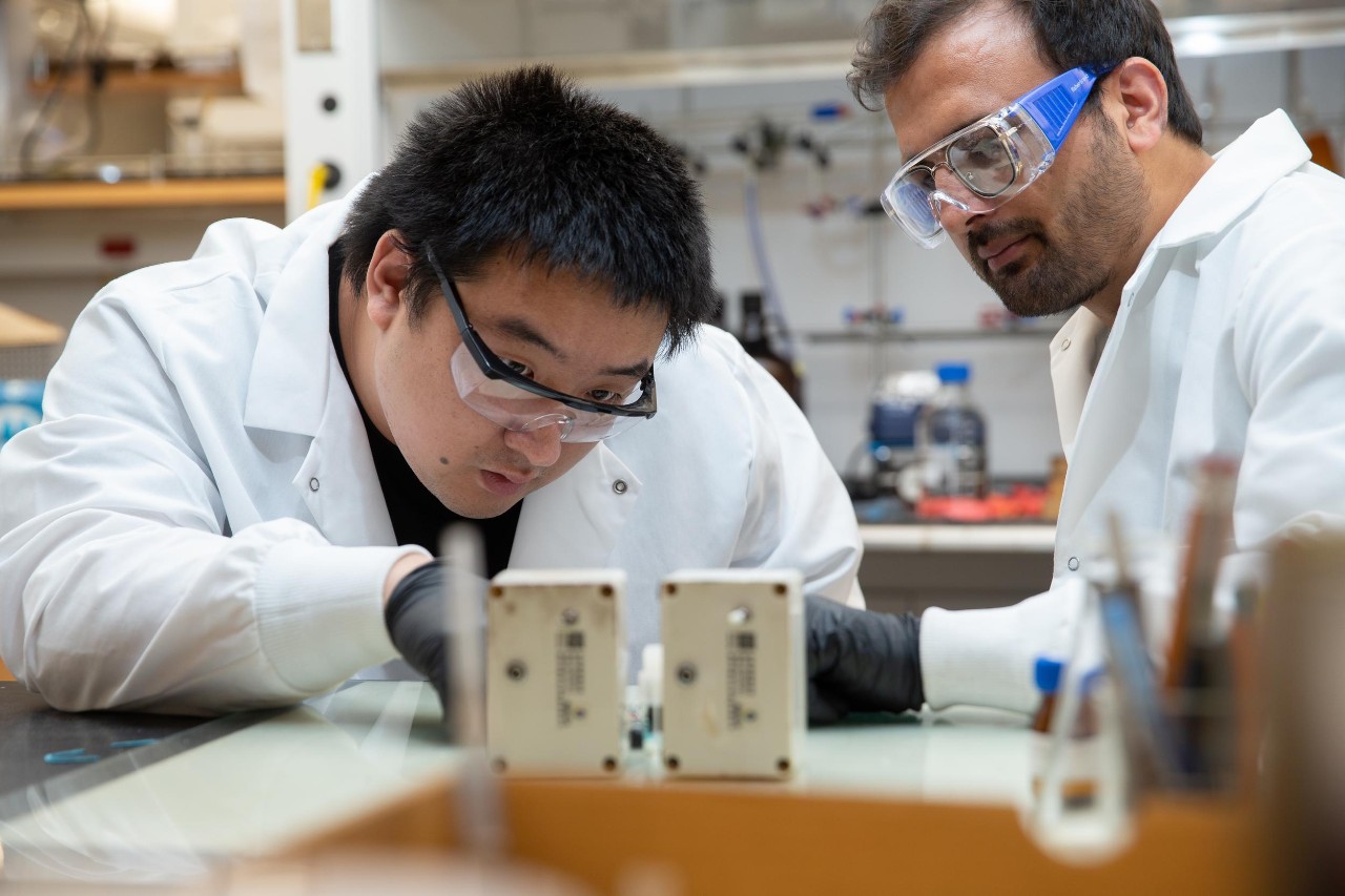 Jianbing "Jimmy" Jiang and his students working in his lab, where they have created a new battery with widespread applications for renewable energy.