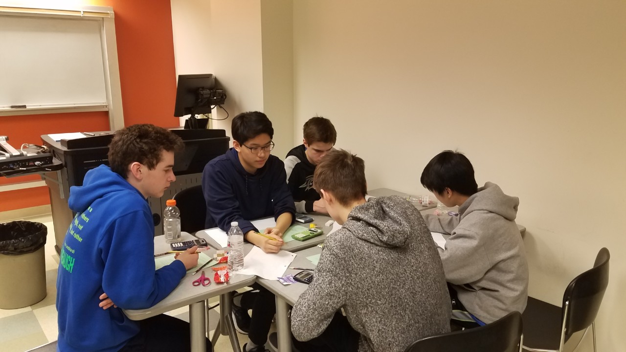 Math Bowl 2019 students working a grouped desks