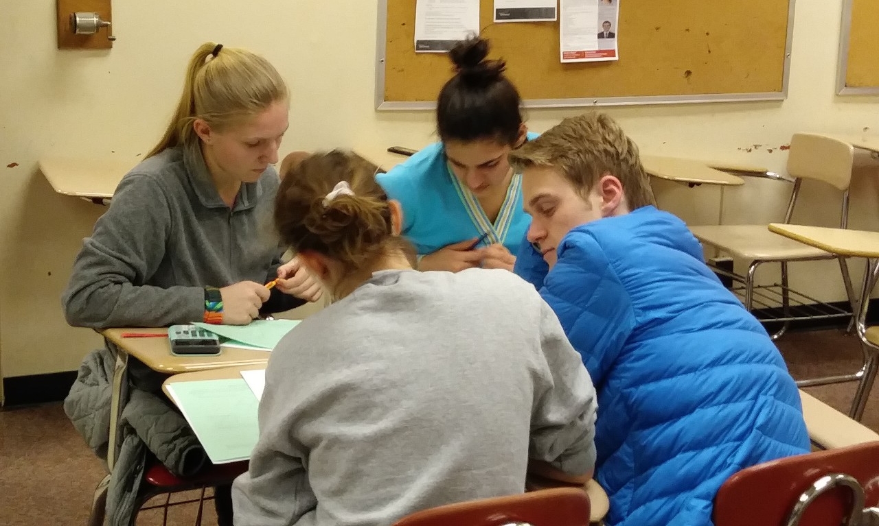 Math Bowl 2019 students working a grouped desks
