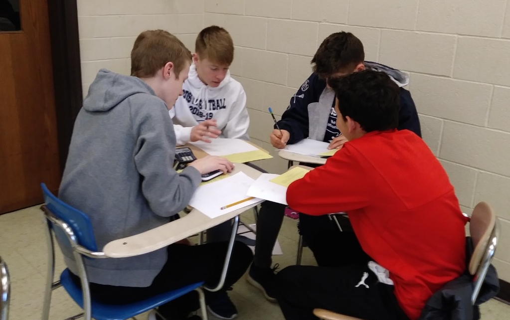 Math Bowl 2019 students working a grouped desks