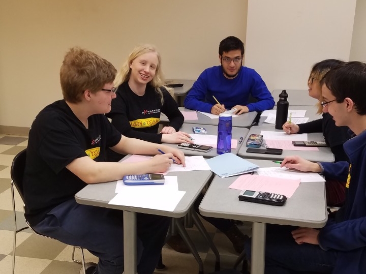 Math Bowl 2019 students working a grouped desks