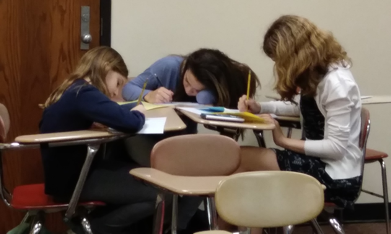Math Bowl 2019 students working a grouped desks