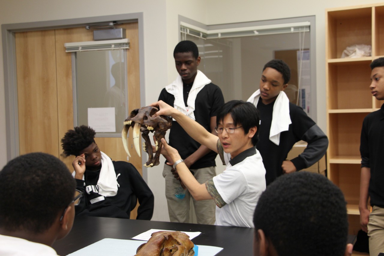Takuya Konishi shows off the powerful jaw structures of ancient predators surrounded by students.