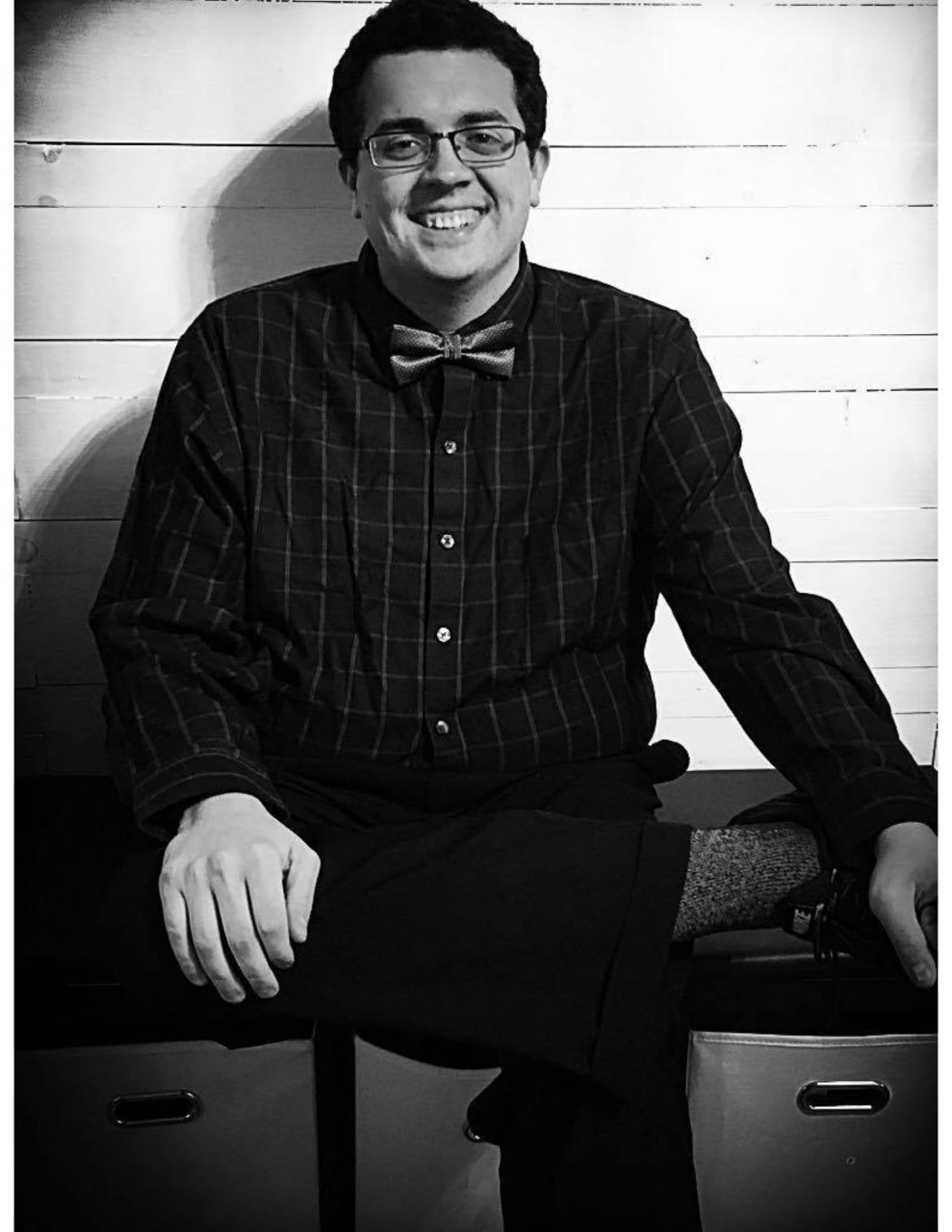 Photo of Danny Rader sitting with legs crossed