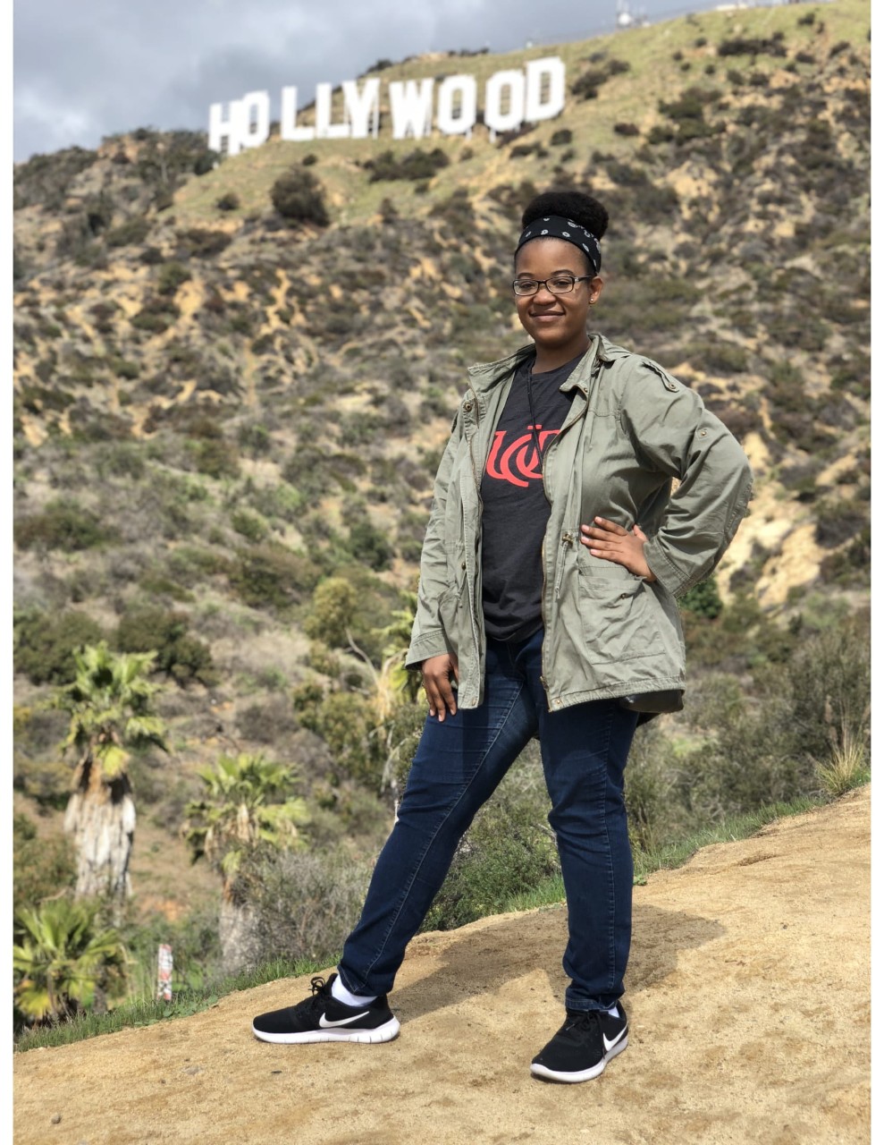 Photo of Stokes standing in front of the Hollywood sign