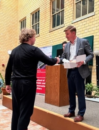 Dr. Andy Lewis awards a student.