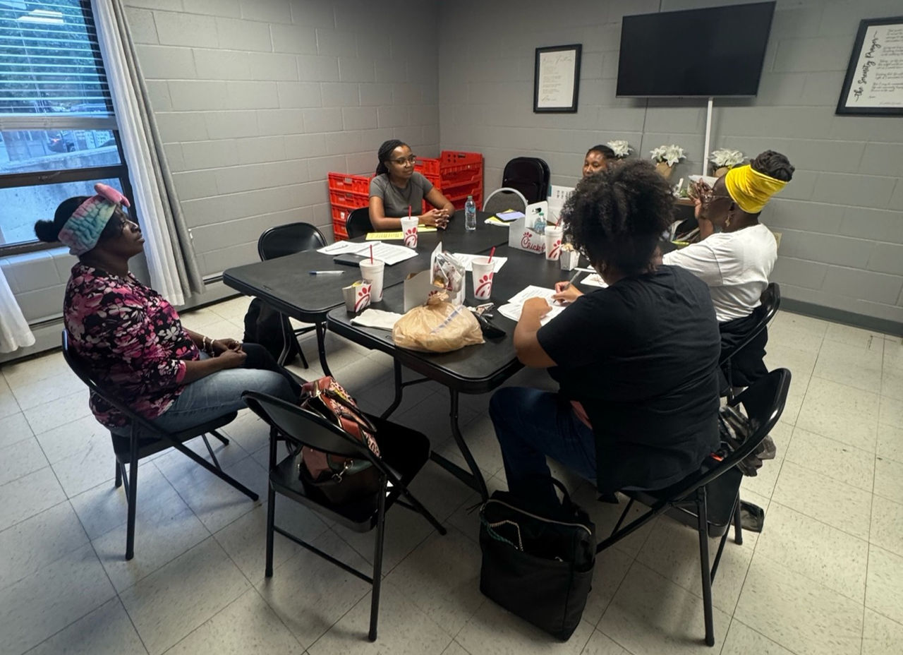 People sitting at a table, mid-discussion