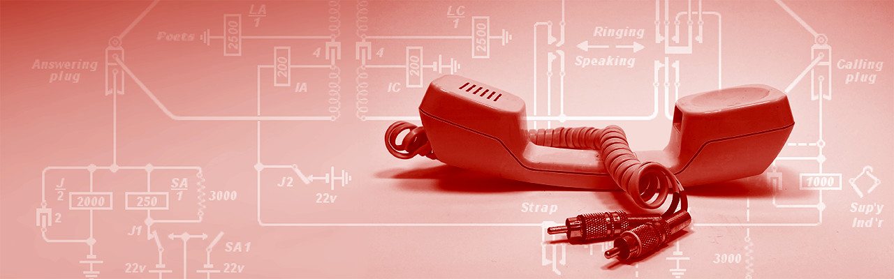 1980's phone handset rewired with red and black audio RCA jacks against a white backdrop