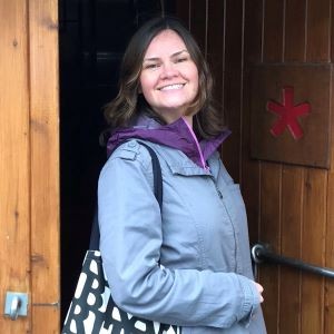 Picture of women smiling at camera with door behind her
