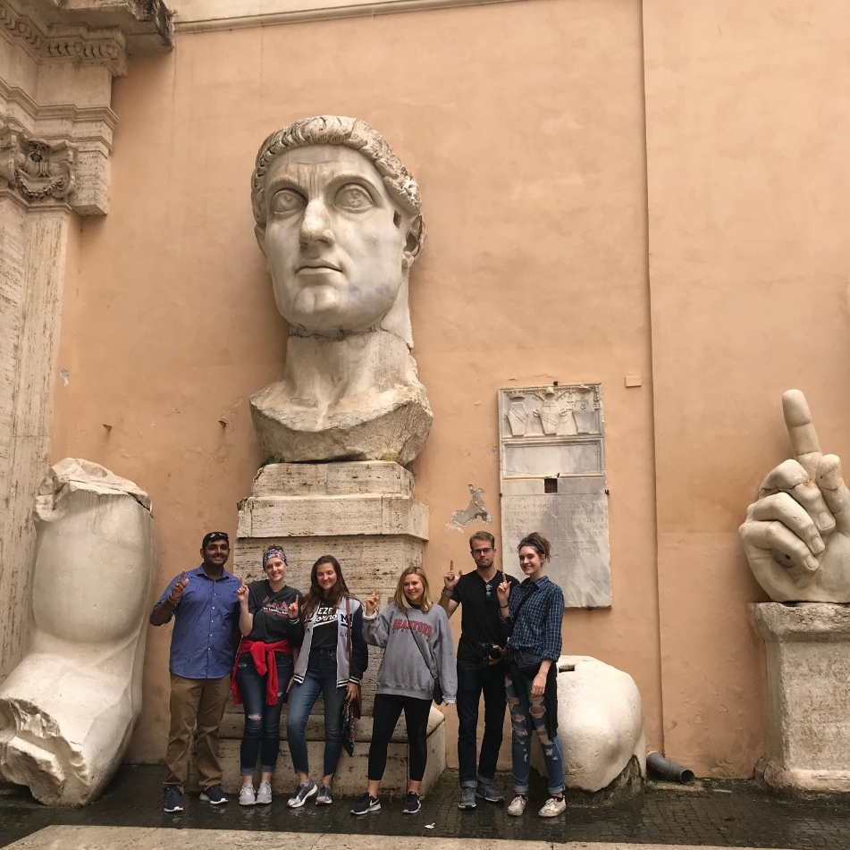 Six students pose in the Courtyard of the Capitoline Museum.